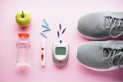 A composite image of running shoes, water bottle, apple and blood glucouse monitor