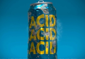 A blue can with yellow text that reads ACID multiple times, partially submerged in water with bubbles around it.